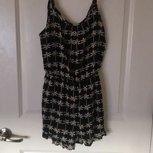 Black romper with tan palm trees.